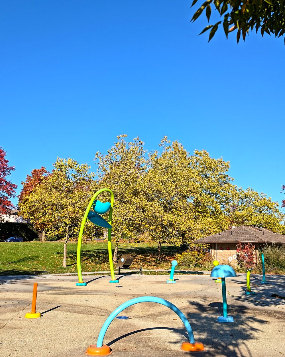 The spray park at Castle Park, with a picnic shelter behind